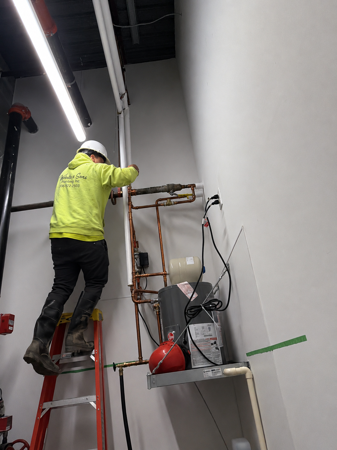 Webster & Sons technician installing copper water distribution and water heater at Dill Dinkers Pickleball Winston-Salem